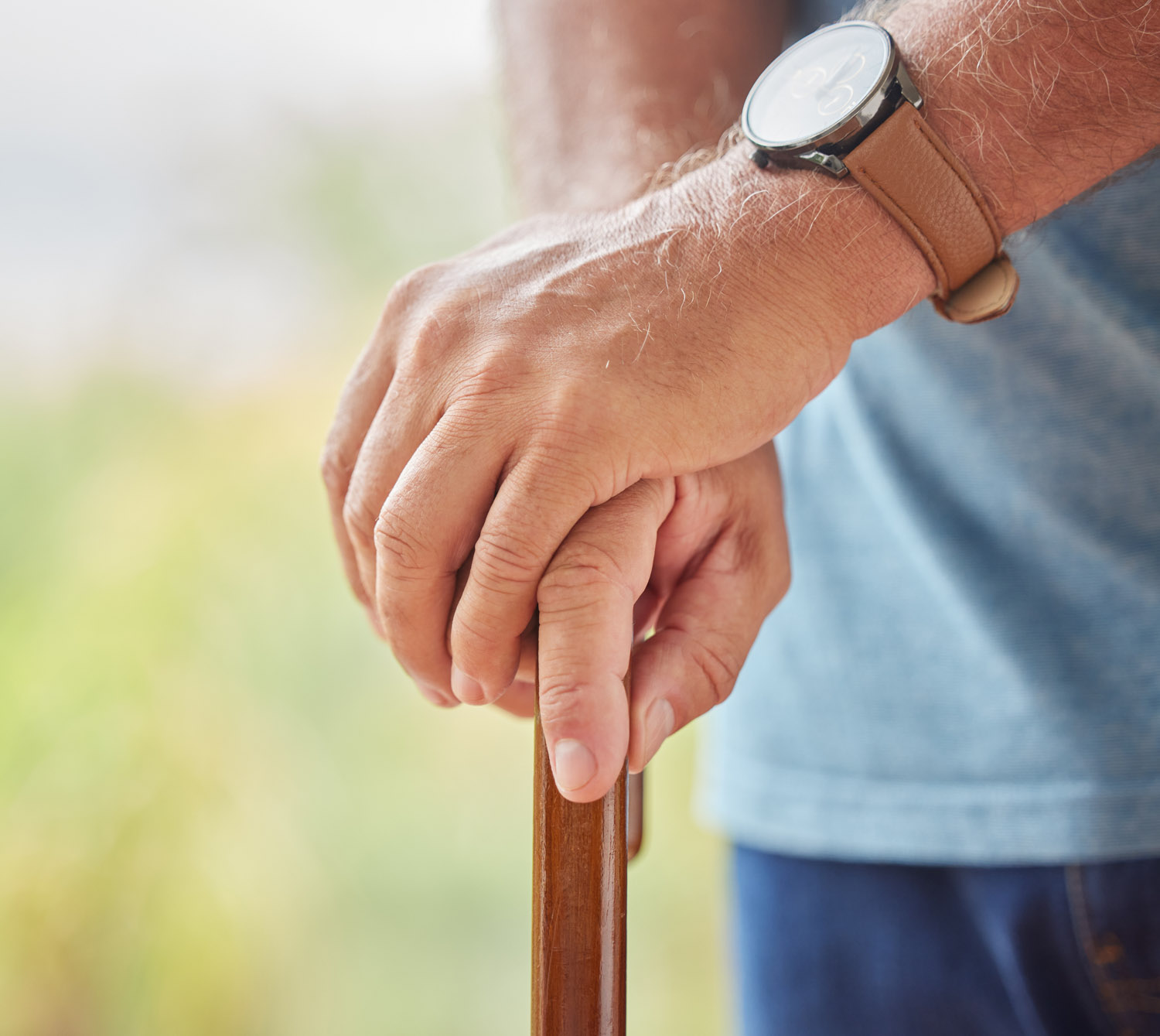 Disability, senior man and hands on stick for support while walk